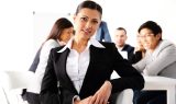 Happy businesswoman sitting in front of business meeting